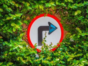 Turn right arrow surrounded by green foliage pointing to Azure